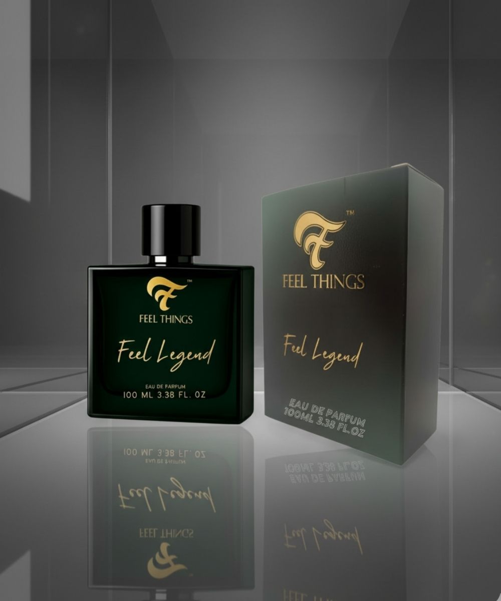 Feel Legend perfume bottle and packaging on a reflective surface with a gray background