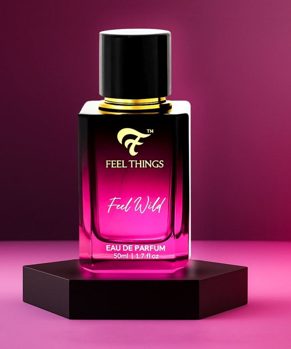 feel wild Perfume bottle labeled 'Feel Things Feel Wild' on a pink background