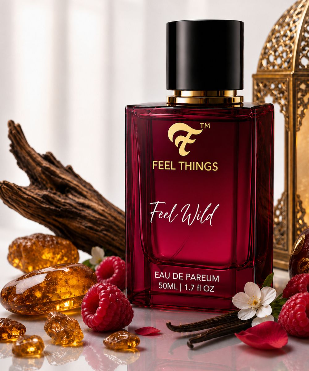 feel wild Perfume bottle labeled 'Feel Things Feel Wild' with vanilla beans, raspberries, and flowers on a light background