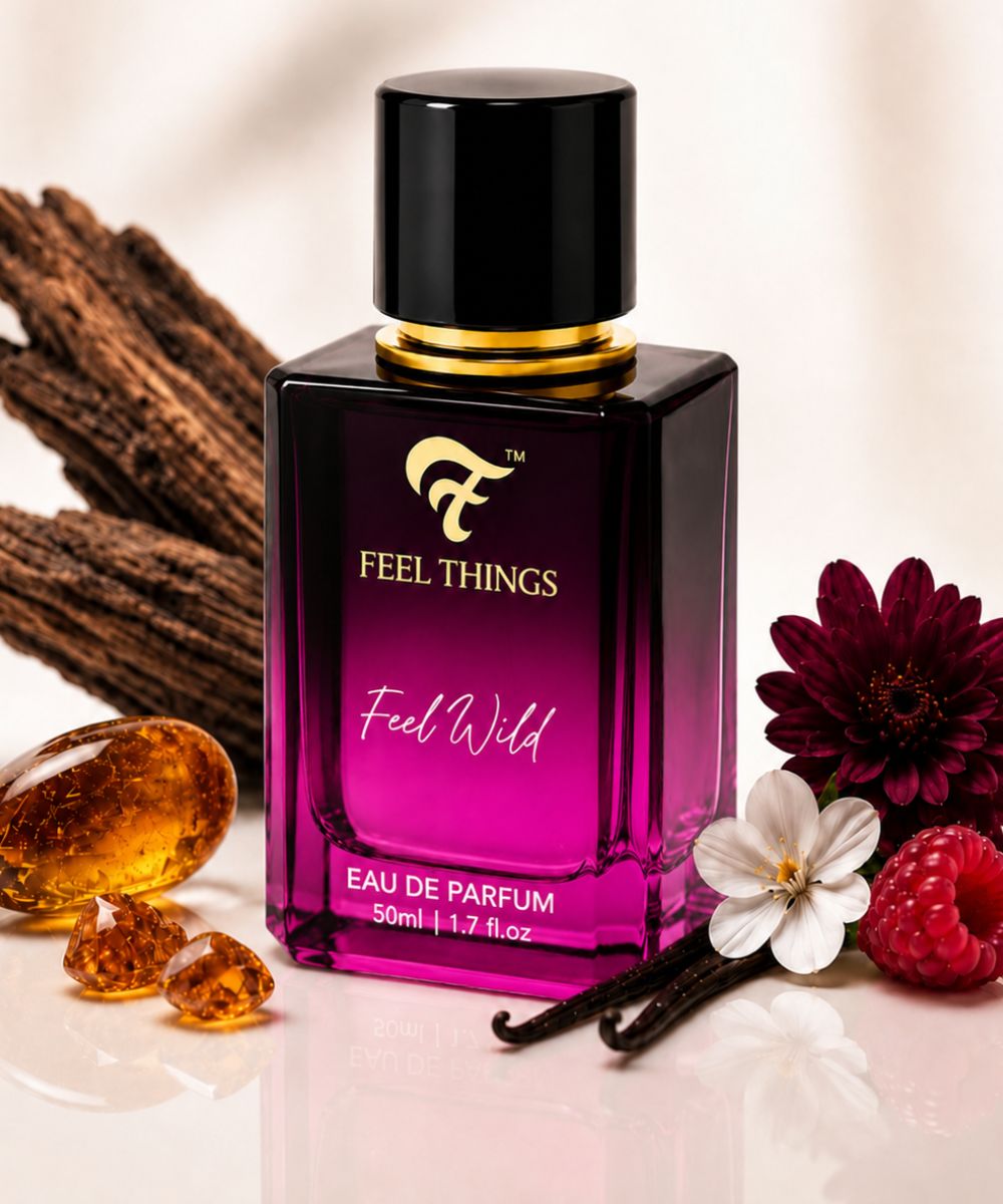 feel wild Perfume bottle labeled 'Feel Things Feel Wild' with vanilla beans, flowers, and berries on a light background