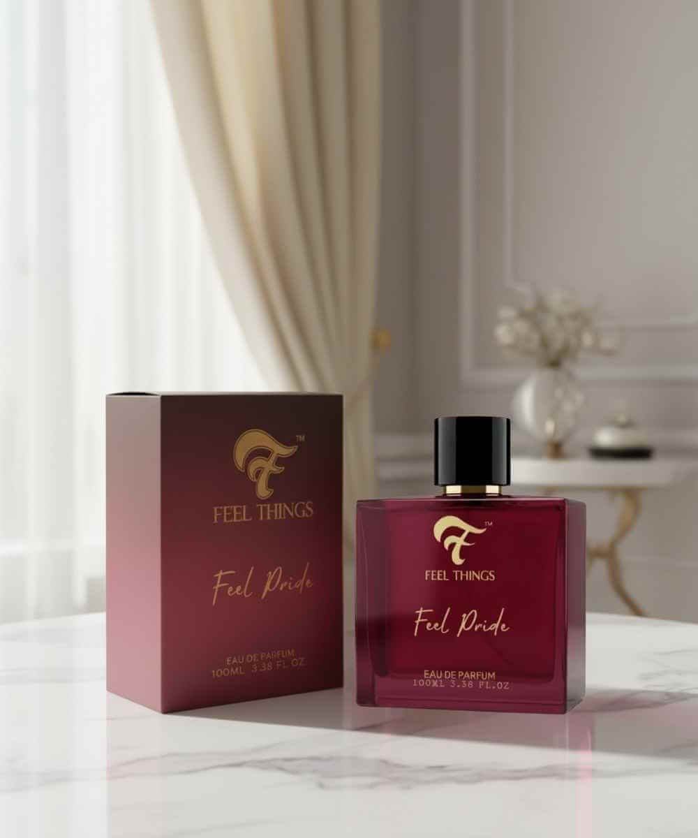 Feel Things Feel Pride perfume bottle and packaging on a marble surface with a blurred background